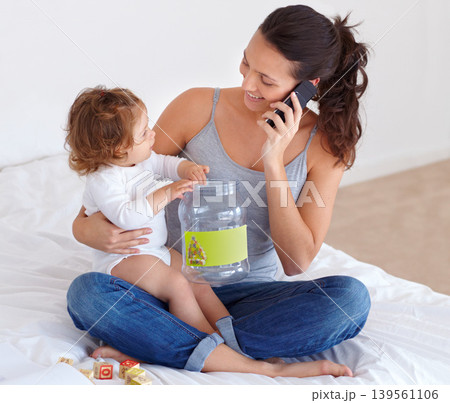 Happy, mom and phone call with baby in home talking on bed with child playing with toys, Smartphone, conversation and mother speaking online, communication and caring for kid in bedroom with blocks Happy, mom and phone call with baby in home talking on bed with child playing with toys, Smartphone, conversation and mother speaking online, communication and caring for kid in bedroom with blocks 139561106