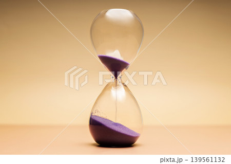 Hourglass with purple sand, passing time, aging process and life transition concepts 139561132