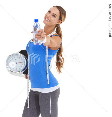 Woman, water bottle and fitness scale for health, diet and exercise, workout or wellness results in studio. Portrait of model with measure tape and liquid or offer for training on a white background Woman, water bottle and fitness scale for health, diet and exercise, workout or wellness results in studio. Portrait of model with measure tape and liquid or offer for training on a white background 139561169