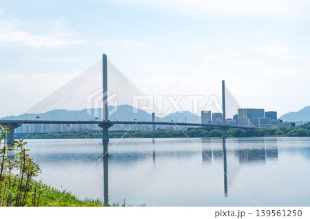 Seoul, South Korea - May. 10, 2026 : Guri-Topyeong Bridge and a peaceful riverside walking path along the Han River in Guri, South Korea Seoul, South Korea - May. 10, 2026 : Guri-Topyeong Bridge and a peaceful riverside walking path along the Han River in Guri, South Korea 139561250