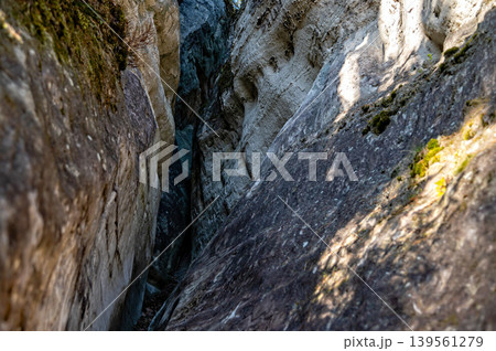 Sandstone rocks are seen near a river in Gauja National Park along a forest trail in Latvia. Sandstone rocks are seen near a river in Gauja National Park along a forest trail in Latvia. 139561279