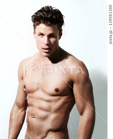 Shower, body and portrait of man with water for washing, cleaning and skincare wellness. Shirtless and muscular male model person with grooming and hygiene for healthy skin by white studio background 139561300