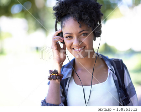 Woman, portrait and headphones as student for music listening, entertainment or streaming. Female person, face and smile with backpack on study campus or outdoor fun for radio, relax or university Woman, portrait and headphones as student for music listening, entertainment or streaming. Female person, face and smile with backpack on study campus or outdoor fun for radio, relax or university 139561312