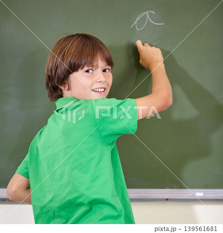 Portrait, chalkboard and kid at school with writing for education and answer while learning. Back, knowledge and youth development in a lesson with student in classroom with chalk and solution Portrait, chalkboard and kid at school with writing for education and answer while learning. Back, knowledge and youth development in a lesson with student in classroom with chalk and solution 139561681