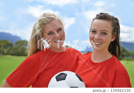 Happy woman, portrait and friends with soccer ball on green grass for sports, game or outdoor match. Female person or football players smile for fitness, training or practice on open field in nature Happy woman, portrait and friends with soccer ball on green grass for sports, game or outdoor match. Female person or football players smile for fitness, training or practice on open field in nature 139562150