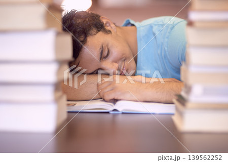 University books, education and tired man sleeping during academy study, research or knowledge learning. College, textbook and Indian student with fatigue, nap and exhausted after reading literature 139562252