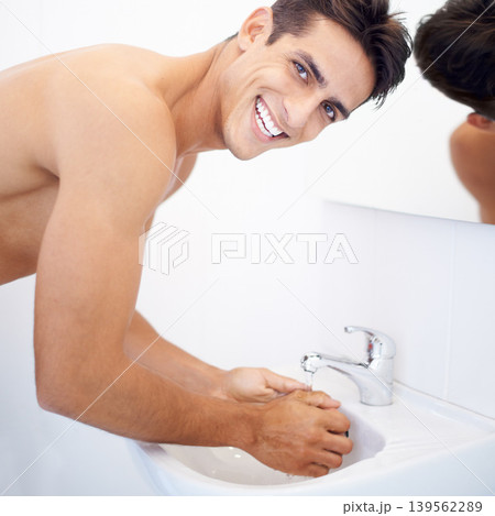 Man, washing hands and portrait for hygiene in mirror, clean and protection from germs. Male person, bathroom and wellness in morning routine, reflection and grooming or self care and basin at home Man, washing hands and portrait for hygiene in mirror, clean and protection from germs. Male person, bathroom and wellness in morning routine, reflection and grooming or self care and basin at home 139562289
