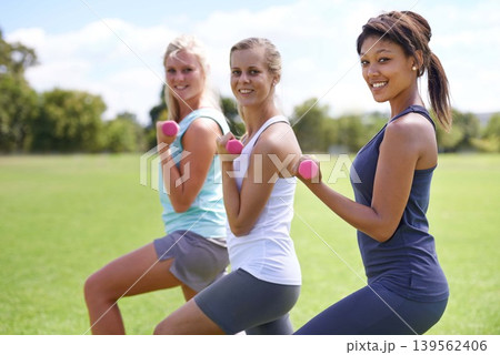Teenage, girl with dumbbells and weightlifting for fitness and muscle, strong athlete group outdoor for sport and bodybuilding. Portrait, exercise equipment park and happy to workout together Teenage, girl with dumbbells and weightlifting for fitness and muscle, strong athlete group outdoor for sport and bodybuilding. Portrait, exercise equipment park and happy to workout together 139562406