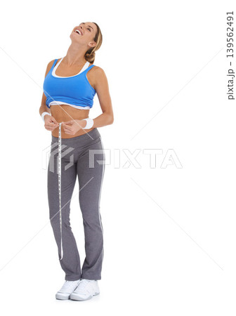 Fitness, measuring tape and portrait of woman in a studio for exercise, training or workout. Sports, laugh and young happy female person with equipment for weight loss isolated by white background. 139562491