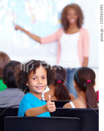 Happy student, portrait and kid with thumbs up in class for winning or success together at school. Young male person, child or boy smile with like emoji, yes sign or OK for education in classroom Happy student, portrait and kid with thumbs up in class for winning or success together at school. Young male person, child or boy smile with like emoji, yes sign or OK for education in classroom 139562495