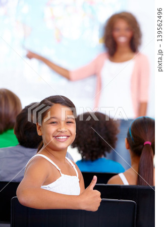 Happy student, portrait and child with thumbs up in class for winning or success together at school. Young female person, kid or girl smile with like emoji, yes sign or OK for education in classroom Happy student, portrait and child with thumbs up in class for winning or success together at school. Young female person, kid or girl smile with like emoji, yes sign or OK for education in classroom 139562496