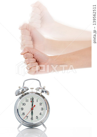 Person, hand and hitting alarm clock for alert, wakeup or deadline on a white studio background. Closeup of fist slamming down on time for stop in motion blur, schedule or management for planning Person, hand and hitting alarm clock for alert, wakeup or deadline on a white studio background. Closeup of fist slamming down on time for stop in motion blur, schedule or management for planning 139562511