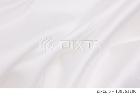 Smooth elegant white silk or satin luxury cloth texture as wedding background. Luxurious background design Smooth elegant white silk or satin luxury cloth texture as wedding background. Luxurious background design 139563186