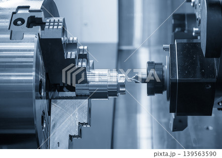 High-precision hole guide drilling using a center drill tool on a metal shaft part with a CNC lathe machine. 139563590