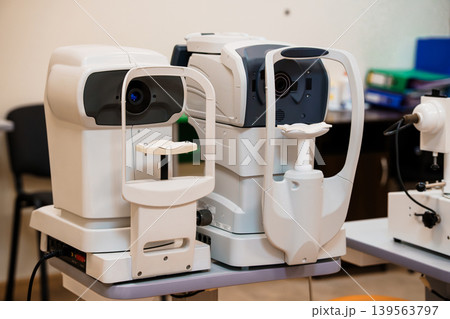 Professional ophthalmology equipment for eye examination in modern clinic with white color scheme and medical technology setup 139563797