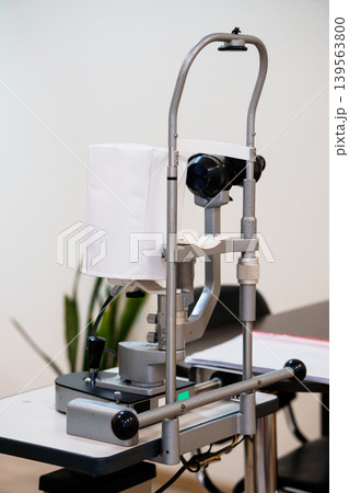 Medical ophthalmology examination equipment and instrument for eye testing in clinical office with gray metal frame on table Medical ophthalmology examination equipment and instrument for eye testing in clinical office with gray metal frame on table 139563800