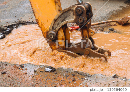 Construction crew works on water main break in street city 139564060