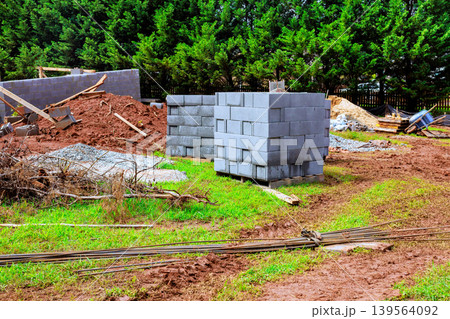 Construction site with building materials cinder blocks gravel path 139564092