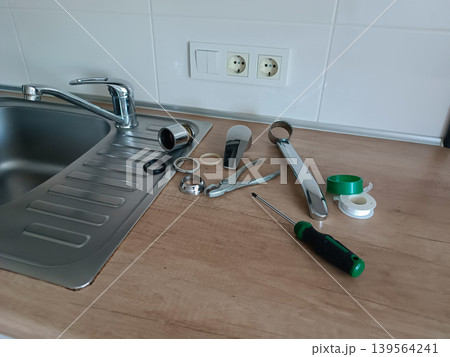 DIY Faucet Repair Tools on Kitchen Sink DIY Faucet Repair Tools on Kitchen Sink 139564241
