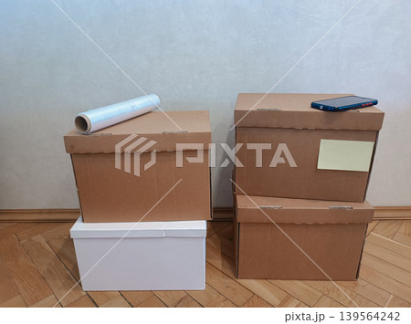 Stack of Moving Cardboard Boxes with Smartphone Stack of Moving Cardboard Boxes with Smartphone 139564242