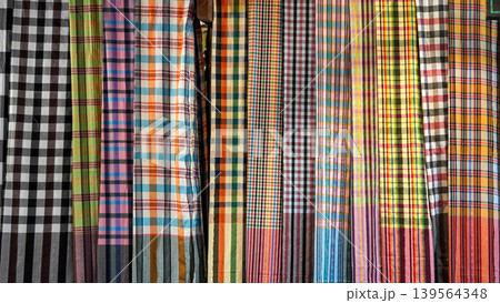 Colorful Thai traditional checkered patterns hanging in a row Colorful Thai traditional checkered patterns hanging in a row 139564348