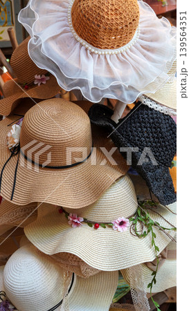 Beautiful collection of various women straw sun hats Beautiful collection of various women straw sun hats 139564351