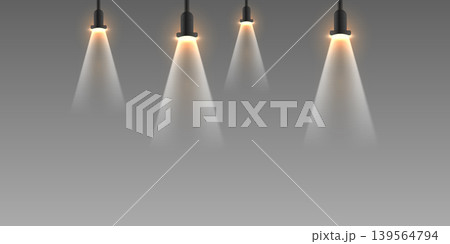 Hanging stage spotlights projecting light beams on smoky background 139564794