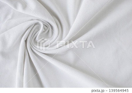 Texture of white velvet fabric with folds and curls. White fabric curl with thin stripes. Texture of white velvet fabric with folds and curls. White fabric curl with thin stripes. 139564945