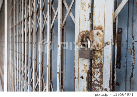 Vintage Folding Metal Gate and Padlock Security on Old Shopfront Vintage Folding Metal Gate and Padlock Security on Old Shopfront 139564971