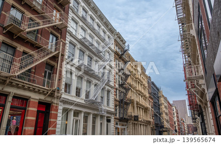 New york, usa august 17,2024. Manhattan soho district showcasing historic cast iron buildings and characteristic fire escapes line an urban street New york, usa august 17,2024. Manhattan soho district showcasing historic cast iron buildings and characteristic fire escapes line an urban street 139565674