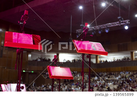 Music stands with sheet music on stage before a concert 139565899