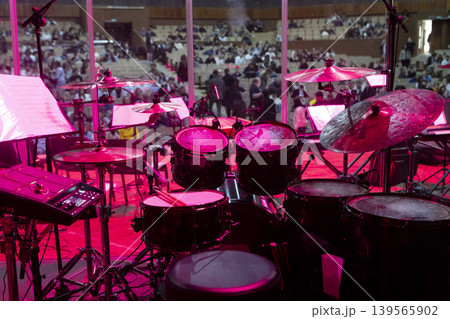 Drum kit on stage before a concert behind a screen 139565902