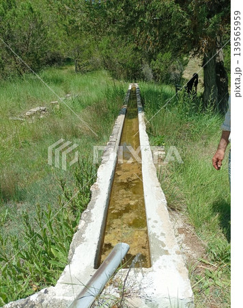 Traditional long stone water trough for livestock in the Spanish countryside 139565959