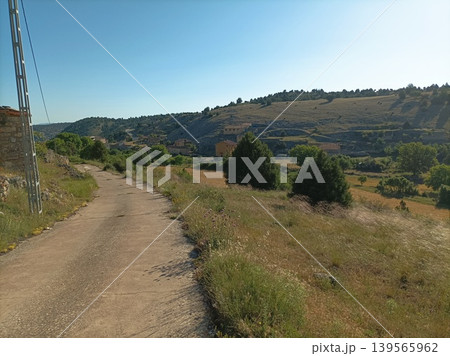 Rural road leading to a small traditional village in Guadalajara, Spain. Rural road leading to a small traditional village in Guadalajara, Spain. 139565962