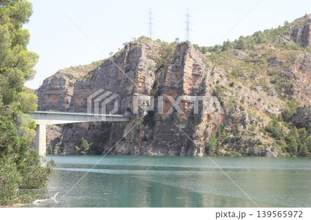 Modern Bridge and Tunnel Through Limestone Cliffs in Cortes de Pallas Modern Bridge and Tunnel Through Limestone Cliffs in Cortes de Pallas 139565972