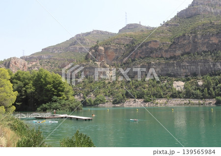 People Swimming near a Wooden Pier at Cortes de Pallas Reservoir, Spain People Swimming near a Wooden Pier at Cortes de Pallas Reservoir, Spain 139565984