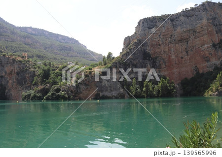 Turquoise Waters of Cortes de Pallas Reservoir and Limestone Cliffs in Valencia, Spain Turquoise Waters of Cortes de Pallas Reservoir and Limestone Cliffs in Valencia, Spain 139565996