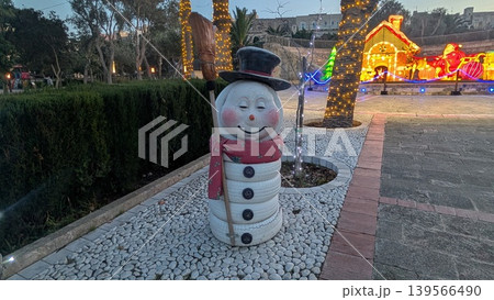Christmas decoration statue of a smiling snowman in a park 139566490