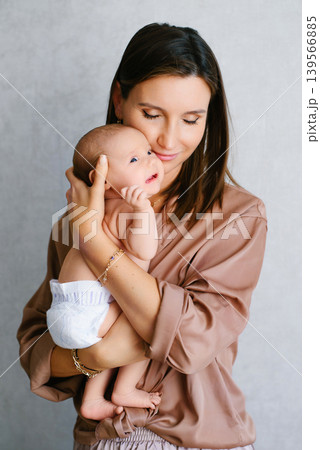 Tender Mother Holding Newborn Baby Tender Mother Holding Newborn Baby 139566885