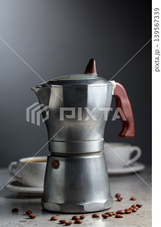 An authentic vintage Italian coffee maker with a retro design and aged metal texture. An authentic vintage Italian coffee maker with a retro design and aged metal texture. 139567339