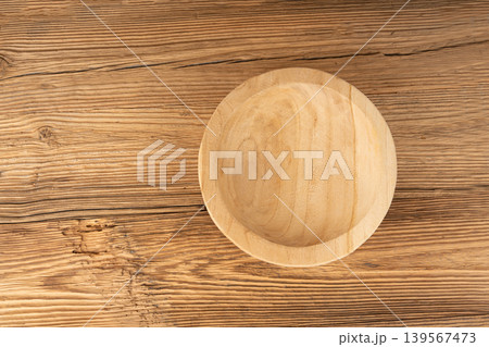 Empty wood bowl on table, plate on wooden tabletop, light rustic dish mockup, eco bio kitchen Empty wood bowl on table, plate on wooden tabletop, light rustic dish mockup, eco bio kitchen 139567473