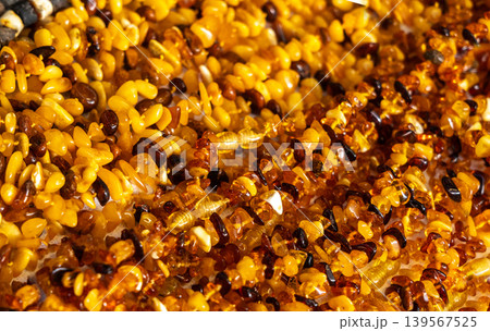 Amber stones market, polished orange gemstones closeup, natural Baltic amber gems jewelry store 139567525
