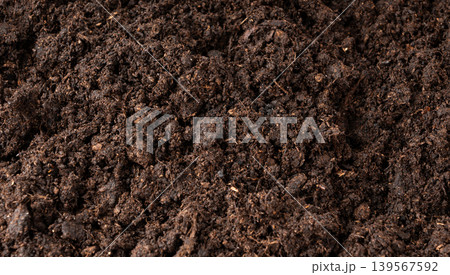 Peat soil textured background. Compost pile, brown garden dirt mound Peat soil textured background. Compost pile, brown garden dirt mound 139567592