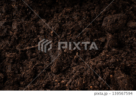 Peat soil textured background. Compost pile, brown garden dirt mound Peat soil textured background. Compost pile, brown garden dirt mound 139567594