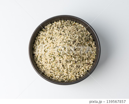 Shelled hemp seeds pile isolated, peeled cannabis grains, marijuana kernels without peel Shelled hemp seeds pile isolated, peeled cannabis grains, marijuana kernels without peel 139567857
