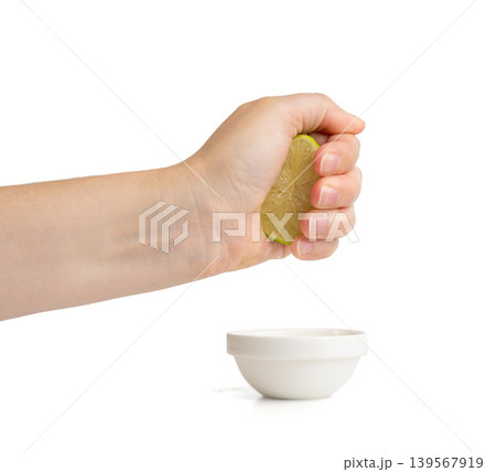 Squeezed lime isolated, squeezed out half green lemon on white background, burnout symbol Squeezed lime isolated, squeezed out half green lemon on white background, burnout symbol 139567919