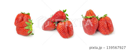 Fresh strawberry isolated, whole ripe straw berry, red juicy imperfect strawberri with green leaves Fresh strawberry isolated, whole ripe straw berry, red juicy imperfect strawberri with green leaves 139567927