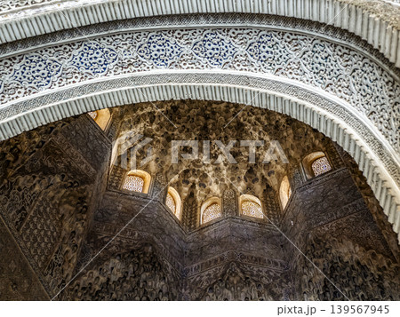 Alhambra Islamic Architecture Interior With Intricate Muqarnas Dome, Carved Stucco Arch and Windows Alhambra Islamic Architecture Interior With Intricate Muqarnas Dome, Carved Stucco Arch and Windows 139567945