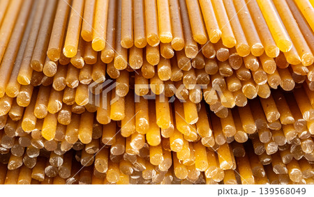 Raw wholegrain brown spaghetti macro texture, dry spagetti pattern Raw wholegrain brown spaghetti macro texture, dry spagetti pattern 139568049