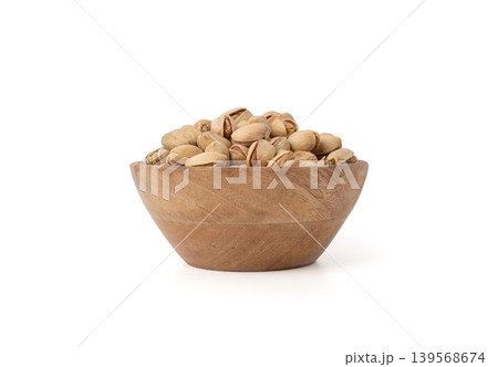 Fried salt pistachio nuts isolated. Baked pistachios pile, roasted green pistache fruit in shell on white Fried salt pistachio nuts isolated. Baked pistachios pile, roasted green pistache fruit in shell on white 139568674
